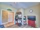 Spacious bonus room with wood floors, storage shelves, with exterior and hallway access at 2654 Rutledge Ct, Winter Haven, FL 33884