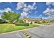 Charming townhome community with lush green lawns and well-maintained landscaping under a clear blue sky at 2654 Rutledge Ct, Winter Haven, FL 33884
