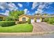 Charming yellow home featuring a manicured lawn and brick driveway leading to attached two-car garage at 2654 Rutledge Ct, Winter Haven, FL 33884