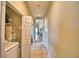 Hallway with tile flooring and a laundry closet featuring a washer and dryer at 2654 Rutledge Ct, Winter Haven, FL 33884