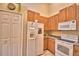 A kitchen featuring wood cabinets, tile floors, and a white refrigerator at 2654 Rutledge Ct, Winter Haven, FL 33884