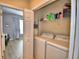 Efficient laundry area with a washer, dryer, and overhead shelving for organized storage solutions at 2654 Rutledge Ct, Winter Haven, FL 33884