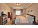 Main bedroom suite featuring a large bed, a window, and closet. Provides a space for rest at 2654 Rutledge Ct, Winter Haven, FL 33884