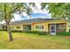 Charming home features screened lanais, lush lawn, and manicured hedges for a relaxing outdoor living space at 2654 Rutledge Ct, Winter Haven, FL 33884