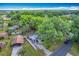 Overhead shot displays the home with large surrounding trees, carport, and spacious driveway at 320 S Elm Rd, Lakeland, FL 33801