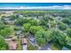 Aerial view showing the property nestled within a green neighborhood, surrounded by trees and residences at 320 S Elm Rd, Lakeland, FL 33801