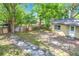 Spacious backyard featuring mature trees and a partial fence for added privacy at 320 S Elm Rd, Lakeland, FL 33801