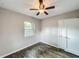 Bedroom featuring one window providing natural light, ceiling fan, and plank flooring at 320 S Elm Rd, Lakeland, FL 33801