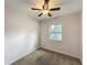 Cozy bedroom featuring a ceiling fan, window with natural light, and neutral carpet at 320 S Elm Rd, Lakeland, FL 33801