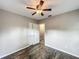 Bedroom with ceiling fan, plank flooring, and closet with sliding doors at 320 S Elm Rd, Lakeland, FL 33801