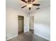 Bedroom with ceiling fan, carpet, closet with sliding doors and view to the next room at 320 S Elm Rd, Lakeland, FL 33801