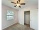 Bedroom with ceiling fan, window, carpet and closet with sliding doors at 320 S Elm Rd, Lakeland, FL 33801