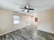 A clean bedroom boasts wood-look floors, a ceiling fan, and a bright window at 320 S Elm Rd, Lakeland, FL 33801