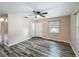 The large bedroom includes wood-look floors, fresh paint, a ceiling fan and a large window at 320 S Elm Rd, Lakeland, FL 33801