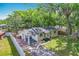 Home's exterior showing its lush landscaping, driveway, covered parking, and fenced backyard at 320 S Elm Rd, Lakeland, FL 33801