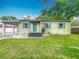 Charming one-story home with a carport and well-maintained lawn, with colorful shutters and front door at 320 S Elm Rd, Lakeland, FL 33801