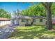 Charming single-story home featuring a well-maintained lawn and a covered parking area at 320 S Elm Rd, Lakeland, FL 33801