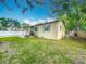 Well-kept home's yard showcasing healthy green grass, complimented by its exterior paint and trim at 320 S Elm Rd, Lakeland, FL 33801