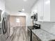Modern kitchen with stainless steel appliances, white cabinets, gray countertops and plank flooring at 320 S Elm Rd, Lakeland, FL 33801