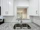 Beautiful granite counters and subway tile backsplash provide a modern, clean aesthetic at 320 S Elm Rd, Lakeland, FL 33801