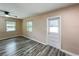 Bright living area with wood-look floors and multiple windows for natural light at 320 S Elm Rd, Lakeland, FL 33801