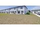 Backyard view of the home with a grassy area and neighboring units at 3265 Vesara Dr, Davenport, FL 33837