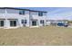 The backyard features a grass lawn, patio, and neighboring units at 3265 Vesara Dr, Davenport, FL 33837