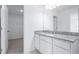 Bathroom with granite countertop vanity and view to walk-in closet with wire shelving on the left at 3265 Vesara Dr, Davenport, FL 33837