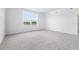 Spacious, bright bedroom with neutral carpet, large window overlooking a pond, and natural light at 3265 Vesara Dr, Davenport, FL 33837