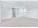Bright, carpeted bedroom with a window and an open door into a hallway showing two additional doors at 3265 Vesara Dr, Davenport, FL 33837