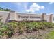 Temples Crossing community sign surrounded by landscaping with flowering bushes at 3265 Vesara Dr, Davenport, FL 33837