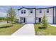Charming townhome with a white garage door and well-maintained front yard at 3265 Vesara Dr, Davenport, FL 33837