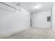 View of the spacious garage, featuring a water heater, and an electrical panel at 3265 Vesara Dr, Davenport, FL 33837