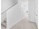 Bright hallway featuring neutral carpet, white walls, and staircase at 3265 Vesara Dr, Davenport, FL 33837
