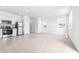 Open floor plan with kitchen and living room featuring stainless steel appliances at 3265 Vesara Dr, Davenport, FL 33837