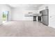 Open floor plan with kitchen and living room featuring stainless steel appliances at 3265 Vesara Dr, Davenport, FL 33837