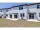 A white siding home with three sliding glass doors and small patios at 3269 Vesara, Davenport, FL 33837