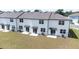 Aerial view of backyards with patios, sliding doors, and AC units in a new construction community at 3269 Vesara, Davenport, FL 33837