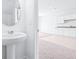 Bright bathroom with a pedestal sink and a view of a cabinet with granite countertops at 3269 Vesara, Davenport, FL 33837