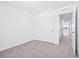 Bedroom with plush carpet, white walls and trim, leading to hall and view to exterior at 3269 Vesara, Davenport, FL 33837