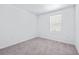 A bright bedroom features a window, carpet, and white walls at 3269 Vesara, Davenport, FL 33837