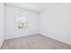 A bright bedroom features a window, carpet, and white walls at 3269 Vesara, Davenport, FL 33837
