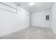 A spacious garage with a door and circuit panel, concrete floor, and white walls at 3269 Vesara, Davenport, FL 33837