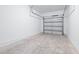 A spacious garage with an open door, concrete floor, and white walls at 3269 Vesara, Davenport, FL 33837