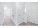 Well-lit hallway with carpeted floors, white walls, and doorways at 3269 Vesara, Davenport, FL 33837