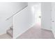 Bright hallway with carpeted flooring, staircase, and white trim at 3269 Vesara, Davenport, FL 33837