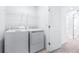 Laundry room featuring white washer and dryer, shelving, and door to hallway at 3269 Vesara, Davenport, FL 33837