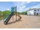 Community playground with slide, swings, and view to a new home construction at 3269 Vesara, Davenport, FL 33837