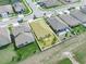 Aerial view of a home, surrounded by lush greenery, with a fenced backyard and a wooden pergola at 3862 Whitney Way, Haines City, FL 33844