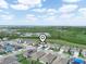 An aerial view of homes with a serene lake nearby, offering a tranquil living experience at 3862 Whitney Way, Haines City, FL 33844